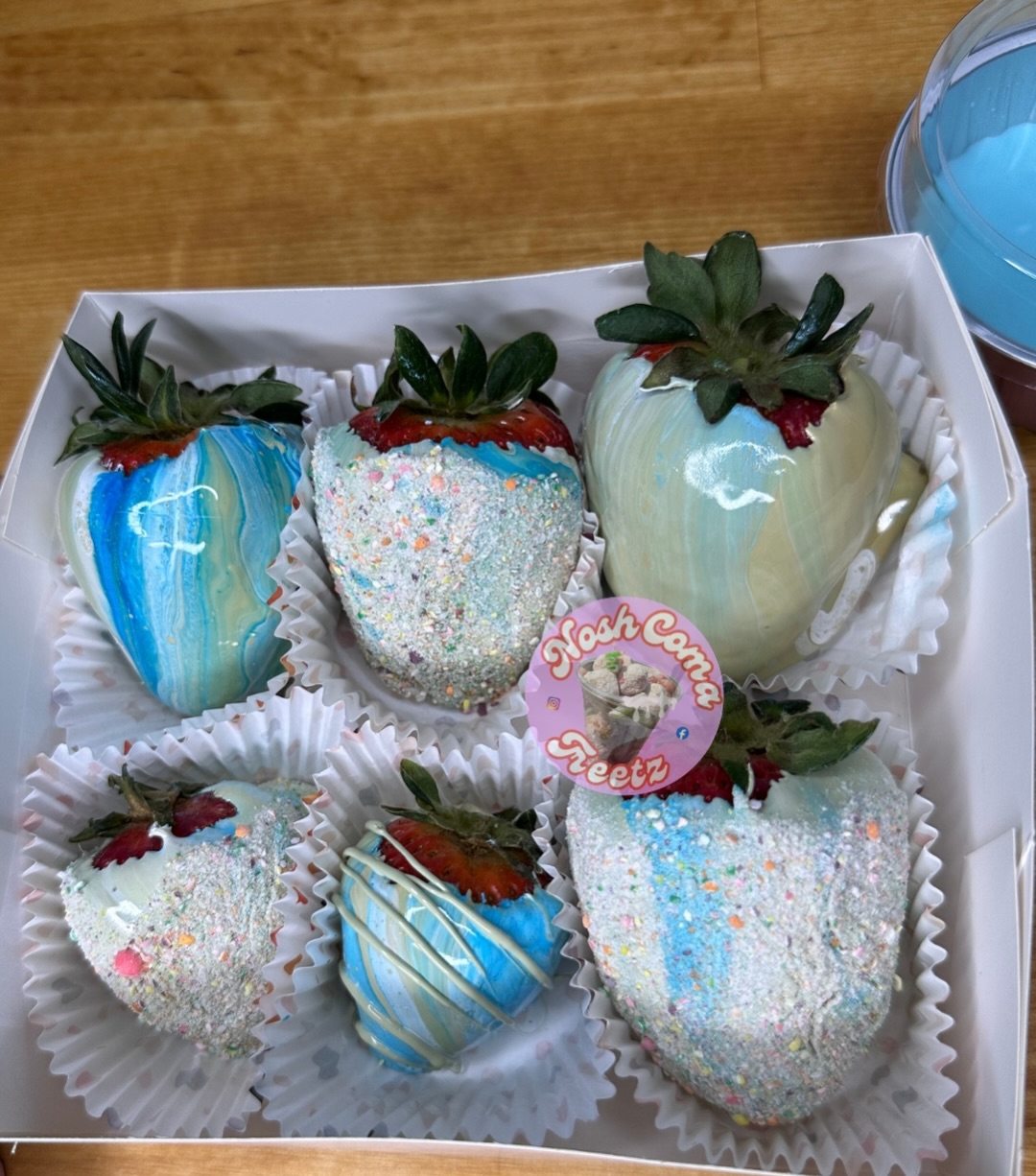 Candied strawberries with blue and white candy coating